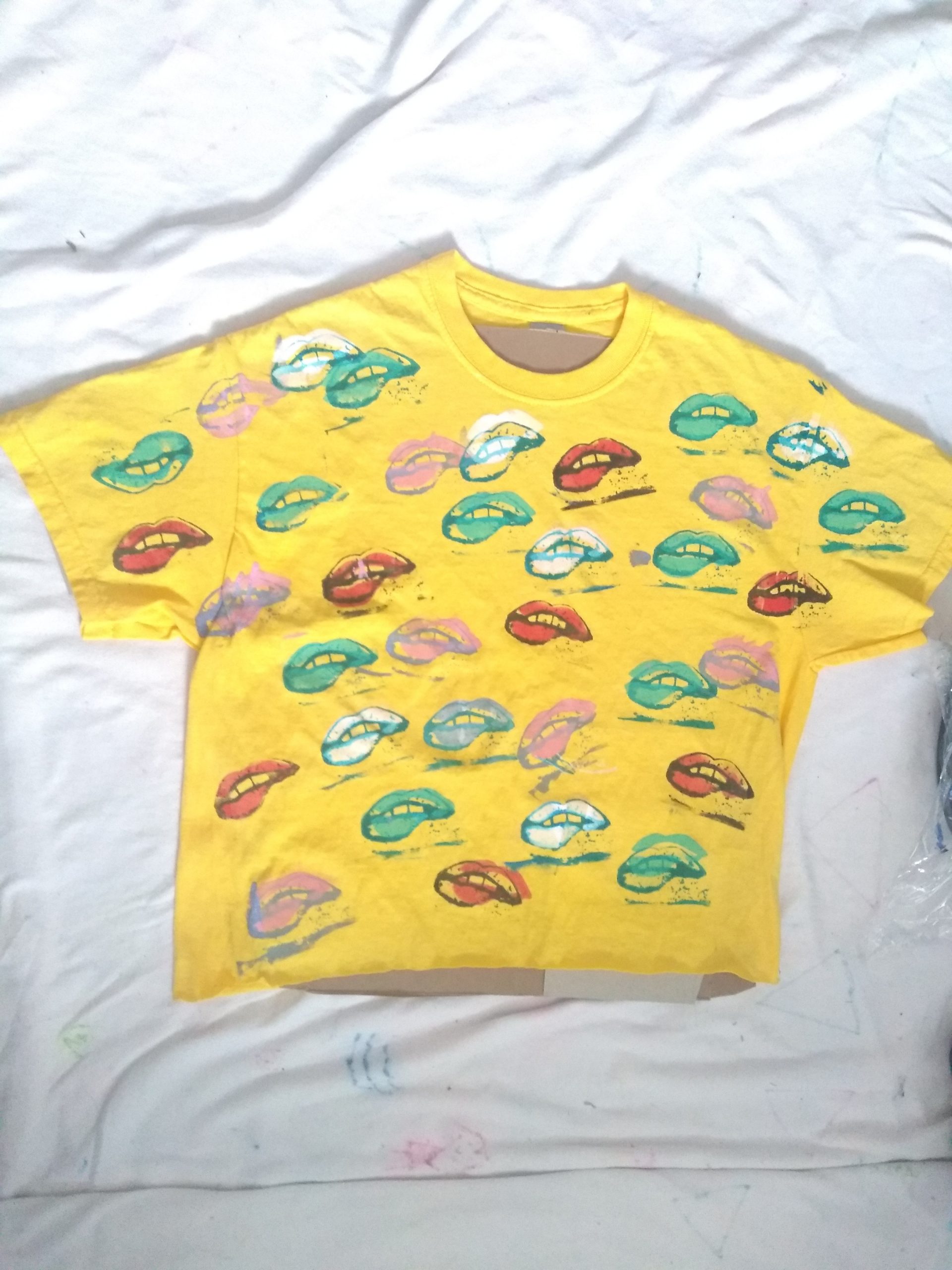 Yellow crop top with mouths with lower lip bites all over