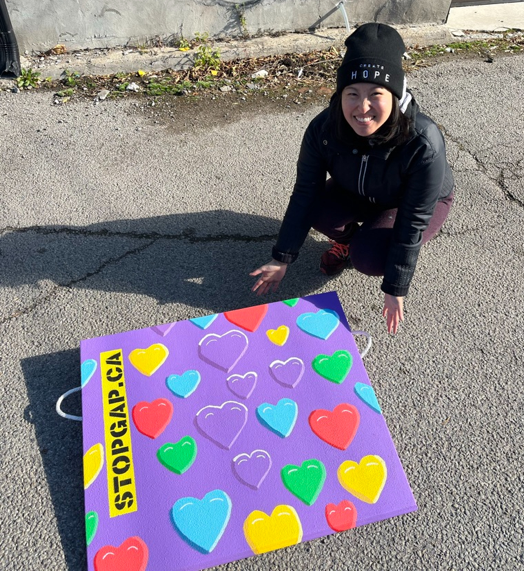 Crouch down to present purple ramp with hearts in yellow, red, purple, blue and green.